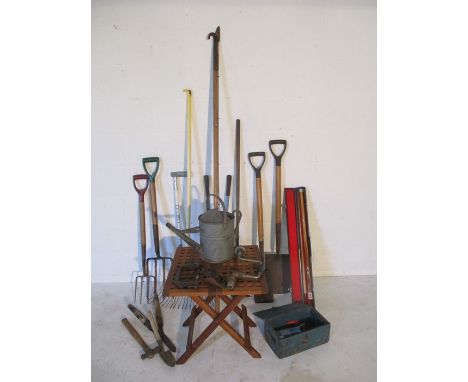 A collection of garden tools, pool cue etc.