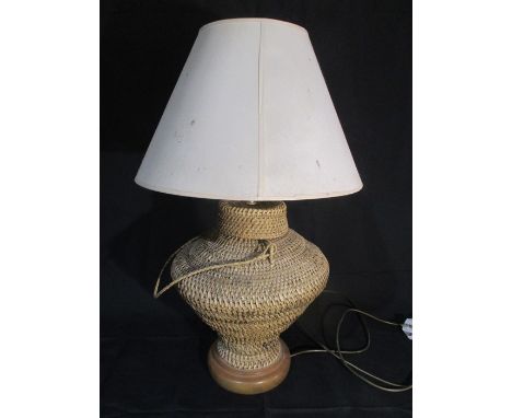 A lamp with a wicker woven base