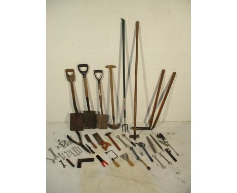 A collection of various tools including spades, hoes, spanners, hammer, hand saw, shears etc