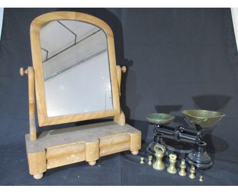 A wooden bathroom mirror with two drawers under, along with a set of vintage scales