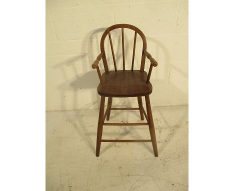 A child's stick back wooden high chair