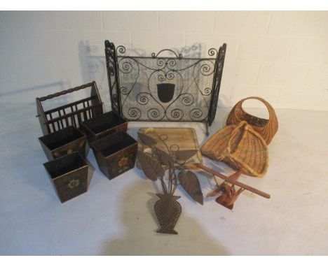 A collection of miscellaneous items including a wrought iron fireguard, wicker carry baskets, model wooden plane, wall hangin