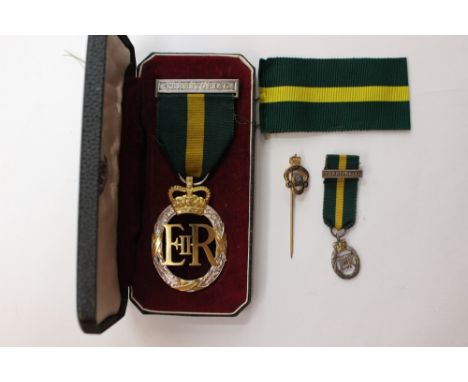 Territorial Queen Elizabeth II medal and Miniature mess dress uniform medal. 1963 on reverse. Complete in case with RBL stick