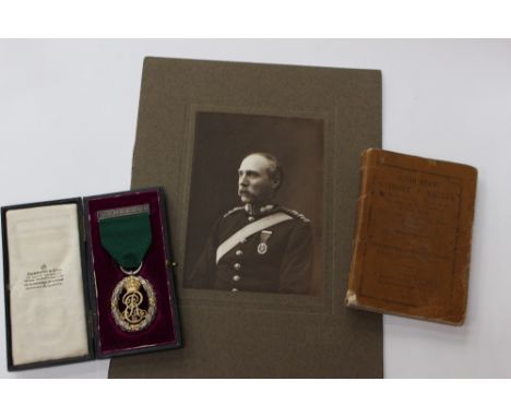 Volunteer Officers Decoration. In original case by Garrard & Co. Comes with an original portrait photo of the recipient weari