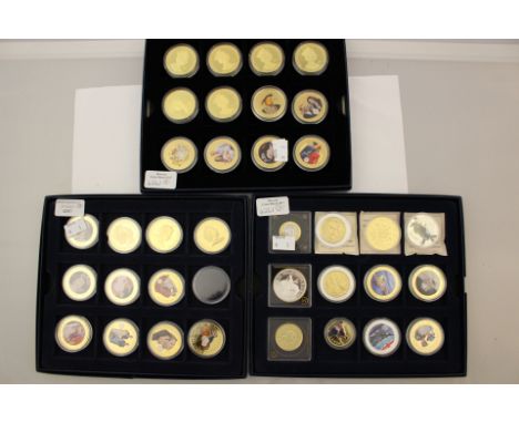 Three Westminster Blue card coin cases holding 35 Enamel Gold and Silver Plated coins, Commemorative Crowns and replicas 