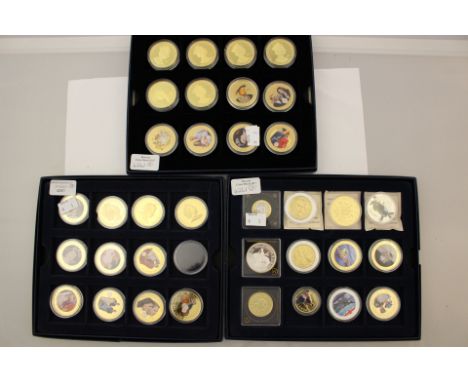 Three Westminster Blue card coin cases holding 35 Enamel Gold and Silver Plated coins, Commemorative Crowns and replicas 