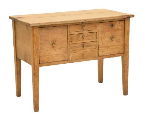 Victorian pine low chiffonier/desk, the central bank of four drawers flanked by two larger drawers, raised on squared support