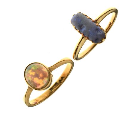 Opal 18ct yellow gold ring, the oval cabochon cut opal displaying violet, indigo, blue, green, orange and red play-of-colour,