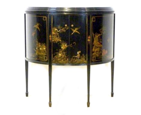 A Japanese black lacquered demi lune sideboard, circa 1910, with two doors enclosing a single shelf, decorated with cranes an