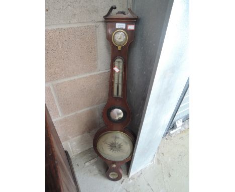 An early 19th century mahogany wheel barometer having humidity and thermometer scales, labelled Revlini, Newcastle
