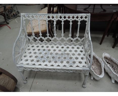 A 19th century style white painted cast garden bench/seat of Regency design