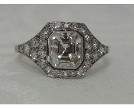 A lady's dress ring having a central cushion cut diamond, approx 1ct to diamond set surround and shoulders, approx 0.75ct in 