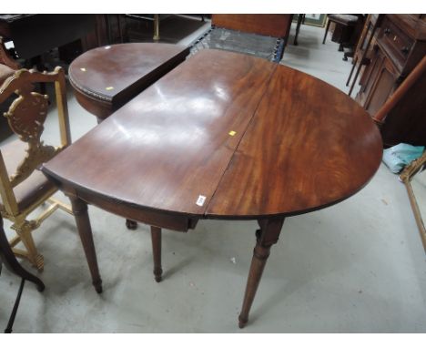 An early 20th century mahogany dining table in the George II style having oval drop leaf top on turned gate legsApprox 54" x 