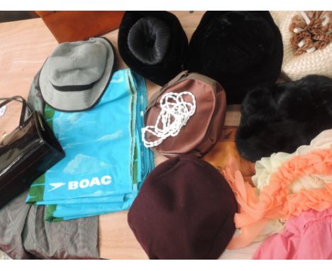A mixed lot of vintage items, including seven hats, two pairs of colourful nylon gloves and a petticoat, a headscarf, a green