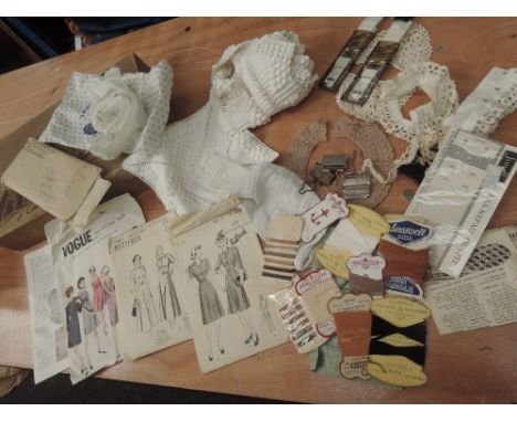 An assortment of interesting vintage and antique haberdashery and similar, including stocking suspenders in original packagin