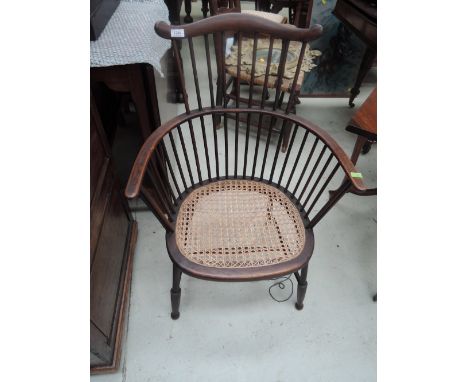 An early 20th century stained frame comb back chair having later cane seat