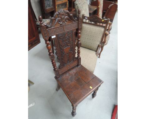 A late Victorian dark oak craftsman hall chair having bobbin carved back with oak leaf detail, with parquetry seat and shaped