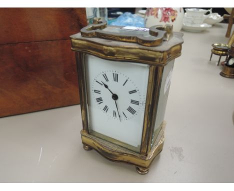 A brass carriage clock of traditional French form