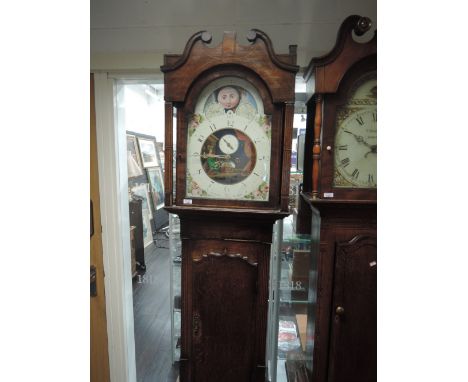  An early 19th century oak longcase clock having swan neck and pillar hood, containing painted dial and 8 day movement, by Jo