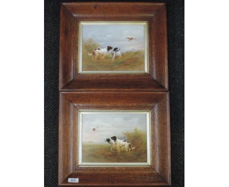 A pair of ceramic plaques by Crown Devon having painted gun dog pictorial decoration, signed by R Hinton, in oak framesCONDIT