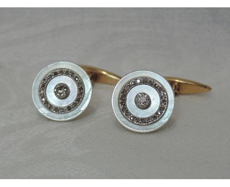 A pair of mother of pearl and diamond dress shirt cufflinks, each having a central brilliant-cut diamond within an old-cut di