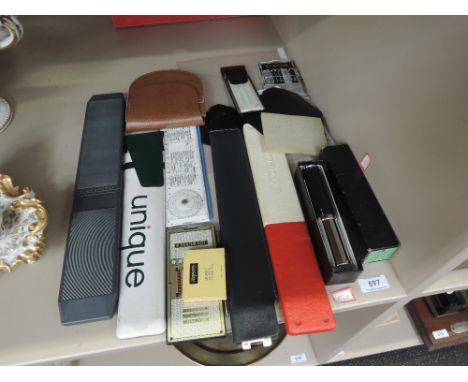 A selection of vintage drawing instruments and similar including Exactus Mini add, slide rules, Otis King calculator, model L