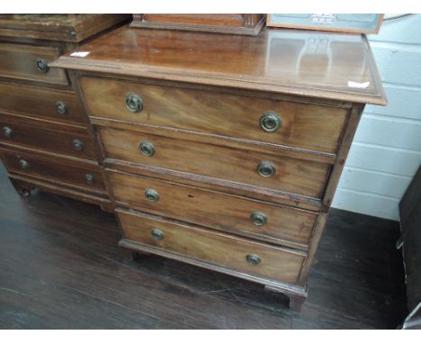 A 19th century mahogany small chest of four long cockbeaded drawers on bracket feet