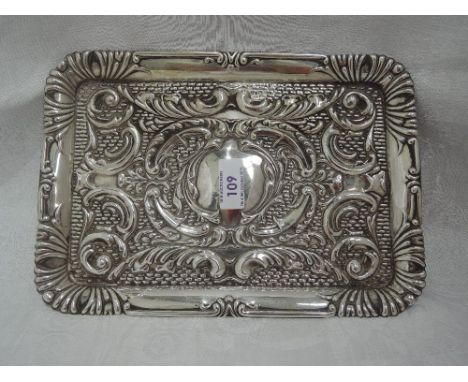 A silver dressing table tray having moulded scroll decoration, plain cartouche and moulded rim, Chester 1910, J &amp; R Griff