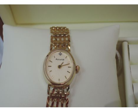 A lady's 9ct gold wrist watch by Accurist having a baton numeral dial with stone to 12 on an oval face on a five bar gate bra