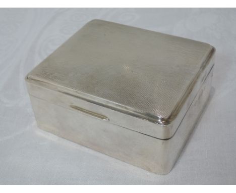 A silver cigarette box having engine turned decoration, Birmingham 1958, Adie BrothersCONDITION REPORT few small dents 10cm x