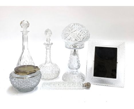 Two cut glass decanters, a cut glass table lamp, silver topped cut glass dress table bottle, etc