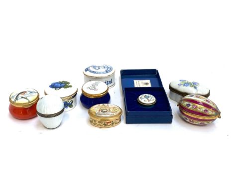 A quantity of enamel an ceramic pill boxes, to include an engine turned 925 silver guilloche opaline enamel egg shaped pill b