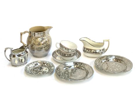 A lot of various silver lustreware to include tea cups and saucers, two milk jugs, and a water jug