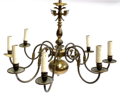 A gilt metal eight arm chandelier, surmounted by a double headed eagle, 71cmW