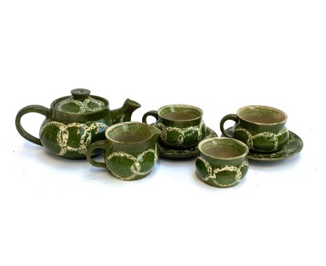 Green glazed stoneware tea set comprising tea pot, two cups with saucers, milk jug, and sugar bowl