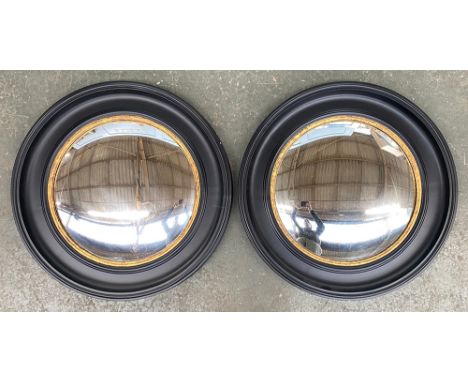 Interior design interest: a pair of Graham &amp; Green circular ebonised and gilt convex mirrors, each 74cmD