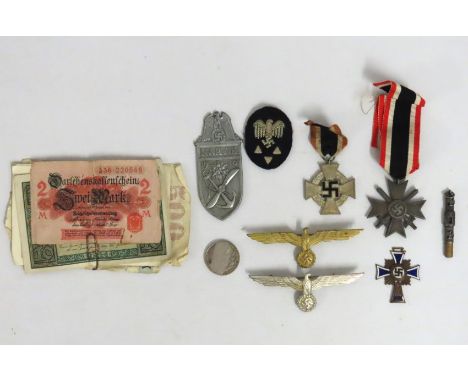 A selection of WW2 Third Reich medals recovered from field of war & prisoners, includes wartime bank notes, gold coloured Kri