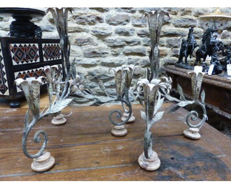 A PAIR OF CONTINENTAL DECORATED WROUGHT IRON FOUR LIGHT TABLE CANDELABRA OF SCROLL FORM WITH LEAVES AND FLOWERS.   H.36cms.