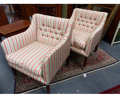 A PAIR OF REGENCY STYLE ARMCHAIRS WITH CHECKERED UPHOLSTERY AND LOOSE SEAT CUSHIONS WITH BRASS AND CERAMIC CASTORS.