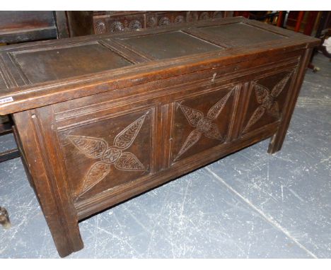 AN 18th.C.OAK COFFER WITH THREE PANEL TOP OVER CONFORMING CARVED PANEL FRONT AND STILE SUPPORTS.   132 x 51 x 66cms.