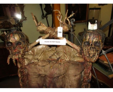 HORROR FILM PROPS.   A WELL CAST RUBBERISED RESIN MODEL OF A SKULL AND BONES THRONE CHAIR.