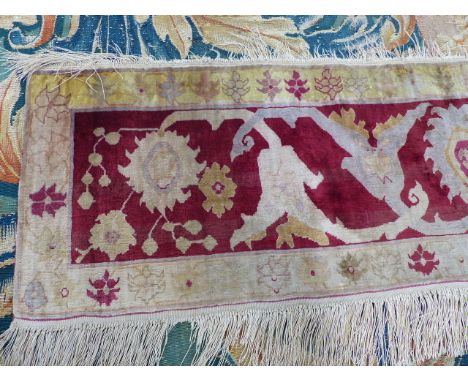 AN ANTIQUE PERSIAN SILK MAT / PANEL OF UNUSUAL DESIGN.   118 x 34cms.