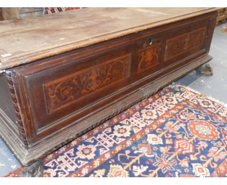 AN ITALIAN 18th.C.WALNUT AND INLAID CASSONNE WITH INLAID ARMORIAL PANEL RAISED ON PAW FEET.   W.173cms.