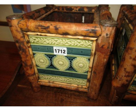 A PAIR OF AESTHETIC BAMBOO MOUNTED TILE SIDED JARDINERES, EACH TILE WITH THREE ROSETTES WITHIN BLUE BANDS, TILES POSSIBLY BY 