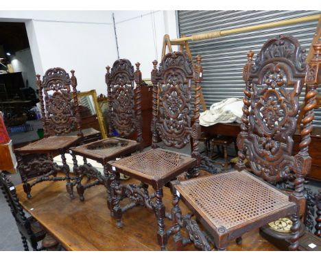 A SET OF EIGHT VICTORIAN CARVED OAK DINING CHAIRS WITH CANED BACK PANELS AND SEATS. TOGETHER WITH A SET OF FOUR VICTORIAN CAR