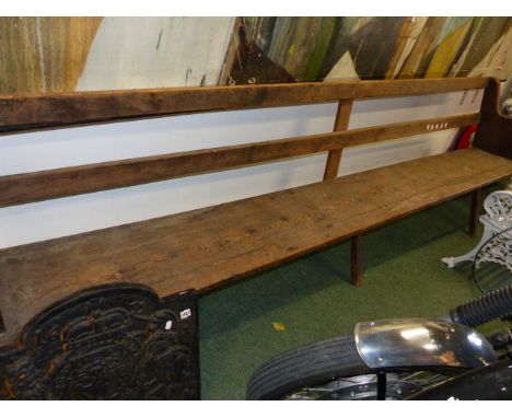 AN ANTIQUE RUSTIC PINE BENCH,  REPUTEDLY FROM THE QUAKER MEETING HOUSE AT SHIPSTON ON STOUR.     L290cms.