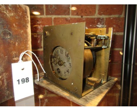 THE SETTLE CLOCK.  A WORKER'S CLOCKING IN CLOCK, THE DIAL WITH ARABIC NUMERALS BEFORE A MECHANISM DRIVING THREE NUMBERED WHEE