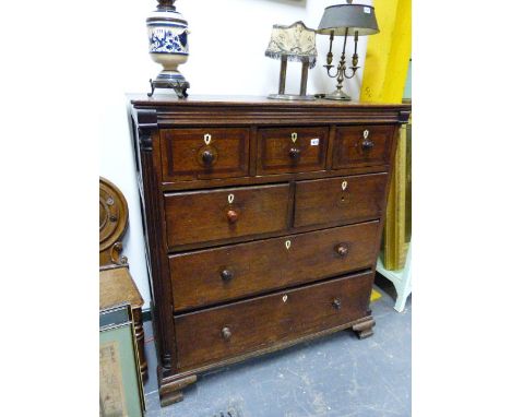 A GEORGIAN OAK CHEST OF FIVE SHORT AND TWO LONG DRAWERS WITH PANELLED SIDES STANDING ON OGEE BRACKET FEET.   110 x 54 x H.120