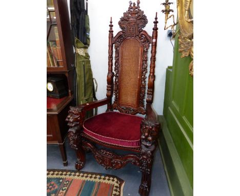 A VERY IMPRESSIVE PAIR OF CARVED HARDWOOD THRONE CHAIRS WITH HIGH BACKS OVER LION MASK ARMS AND PAW FEET UNITED BY ARMORIAL S