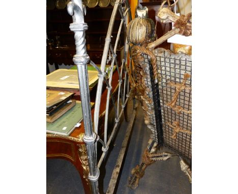AN IRON GOTHIC REVIVAL STYLE DOUBLE BED WITH ARCH FORM ENDS AND FLEUR DE LYS FINIALS.
